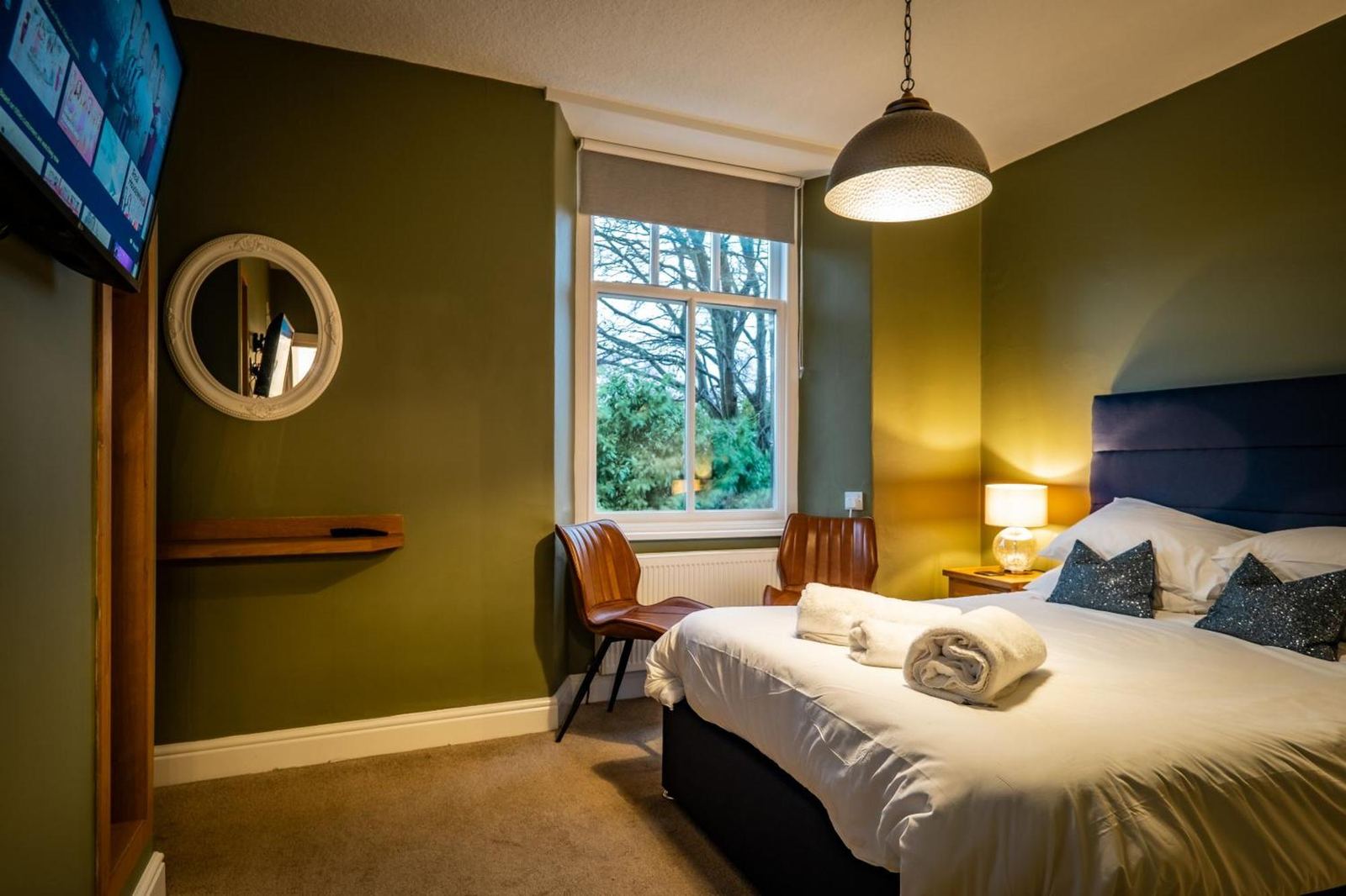 Double bedroom at Glen Wynne Guest House with sage green panelled walls